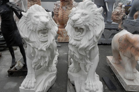 Outdoor large stone roaring lion statues in front of house